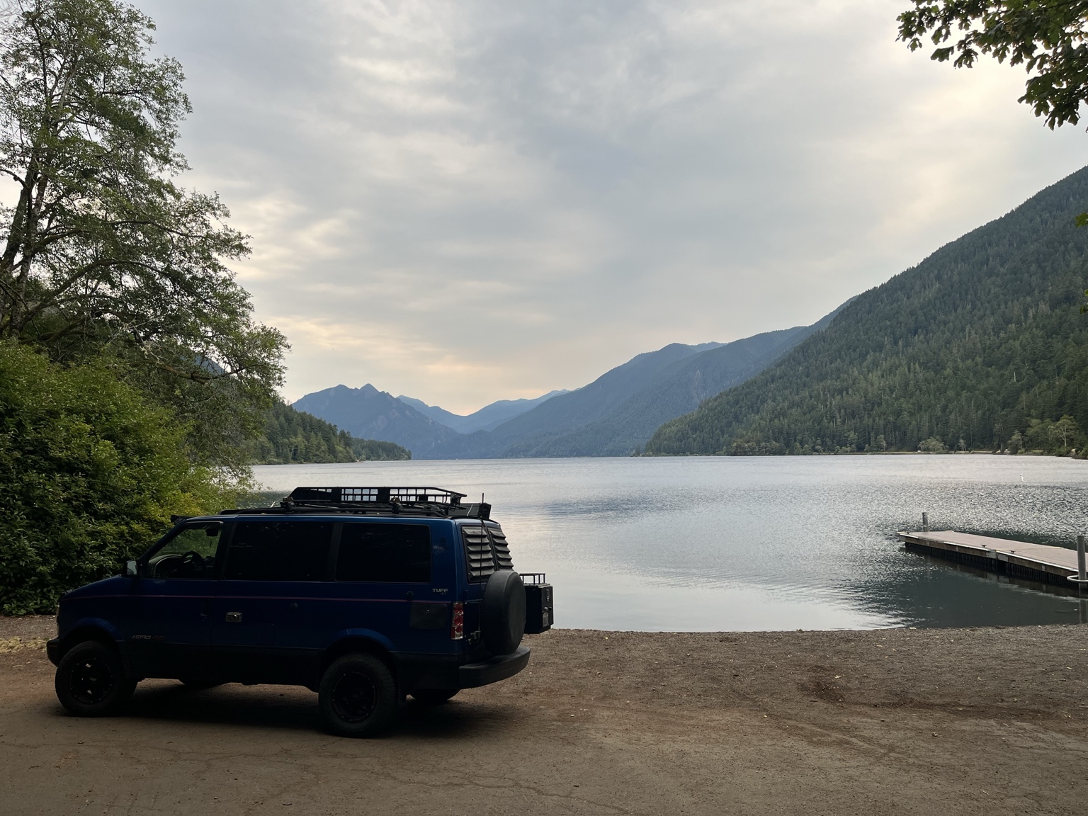 Blue Chevy Astro beside Lake Crescent