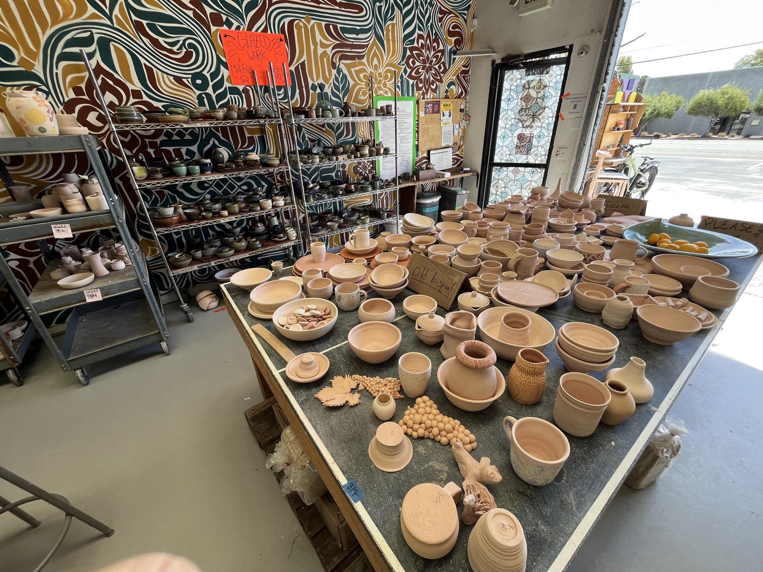 Ceramic work filling a studio table at Santa Cruz Clay
