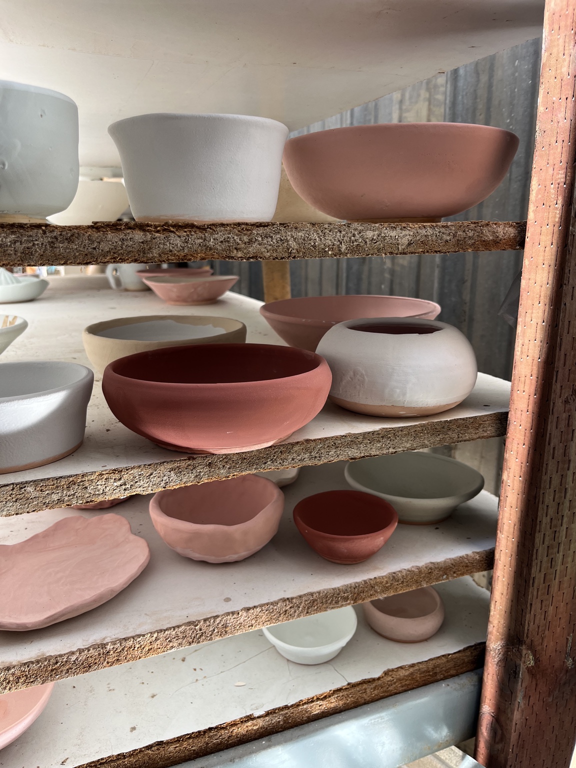 Bowls and dishes arranged on a ceramics ware rack